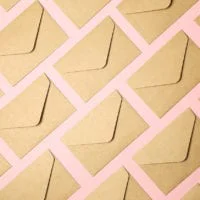 Kraft brown paper envelopes on pink background Kraft brown paper envelopes on pink background