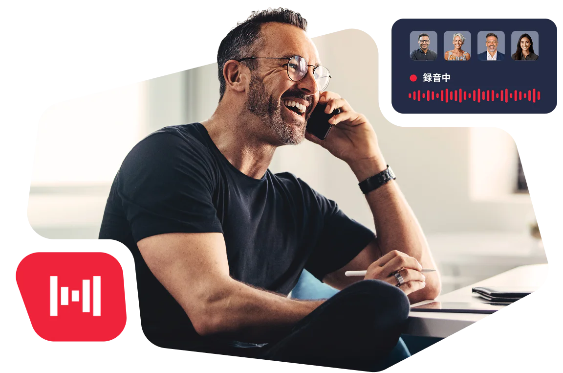 Man smiling while talking on phone with a computer displaying a recording in progress notice.