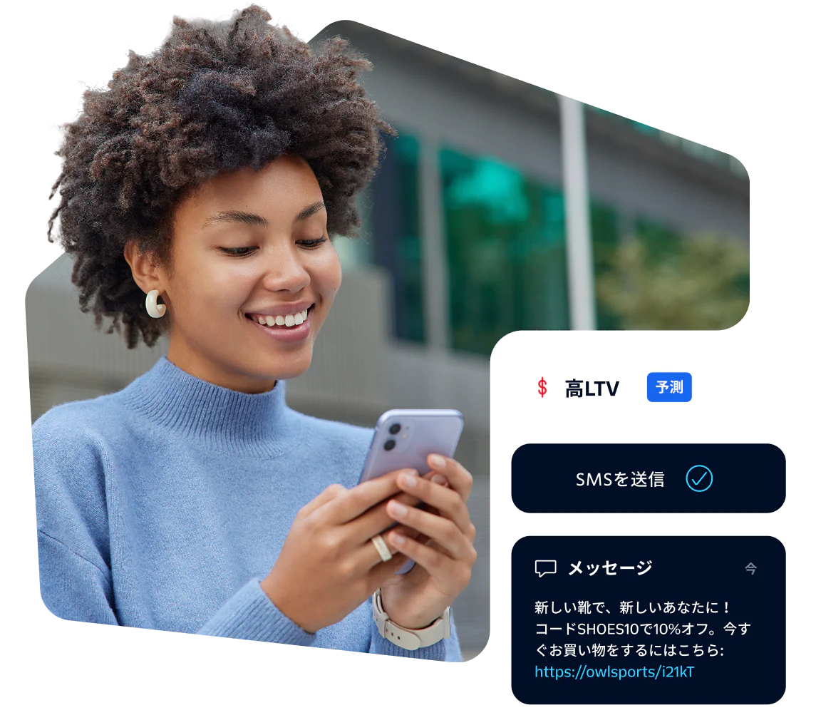 Smiling woman looking at her phone with SMS notification on screen.