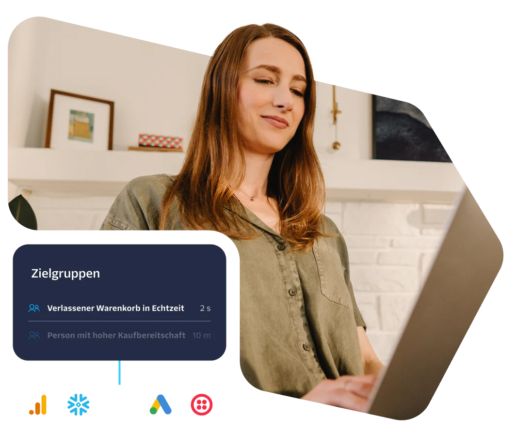 Woman looking at a laptop screen with data on audience engagement and behavior.