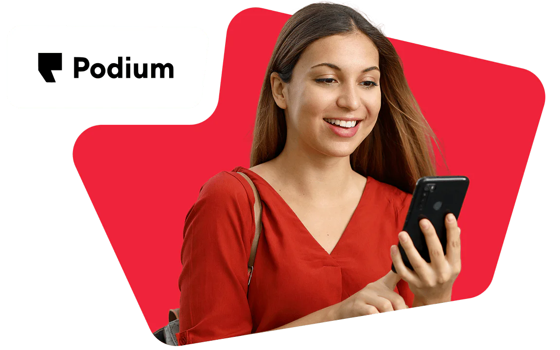 Redheaded woman with glasses smiles, sitting at a laptop, with the Postscript logo in the background.