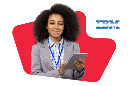 Woman in a gray suit holding a tablet, standing in front of IBM logo with red background.