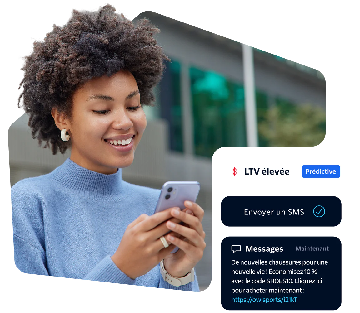 Smiling woman looking at her phone with SMS notification on screen.