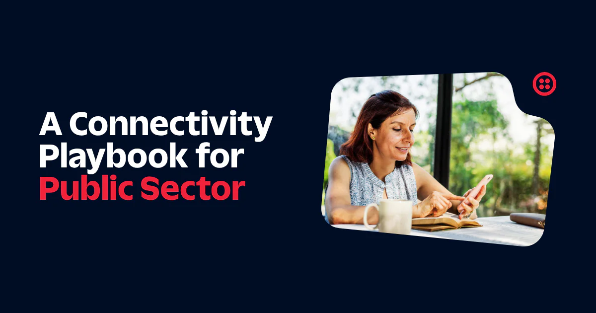 Woman using a smartphone and taking notes next to the text A Connectivity Playbook for Public Sector