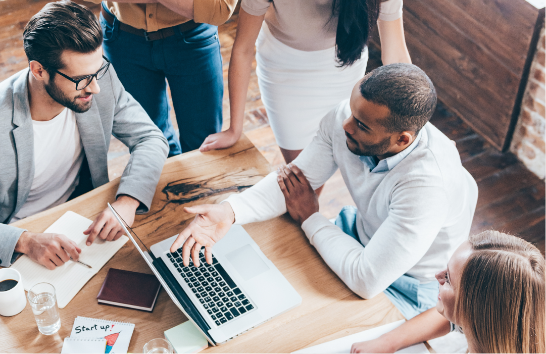 Engineers discussing AI automation of contact center operations at a table