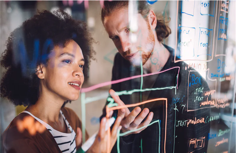 Developers strategizing over UI dialpad implementation on a board