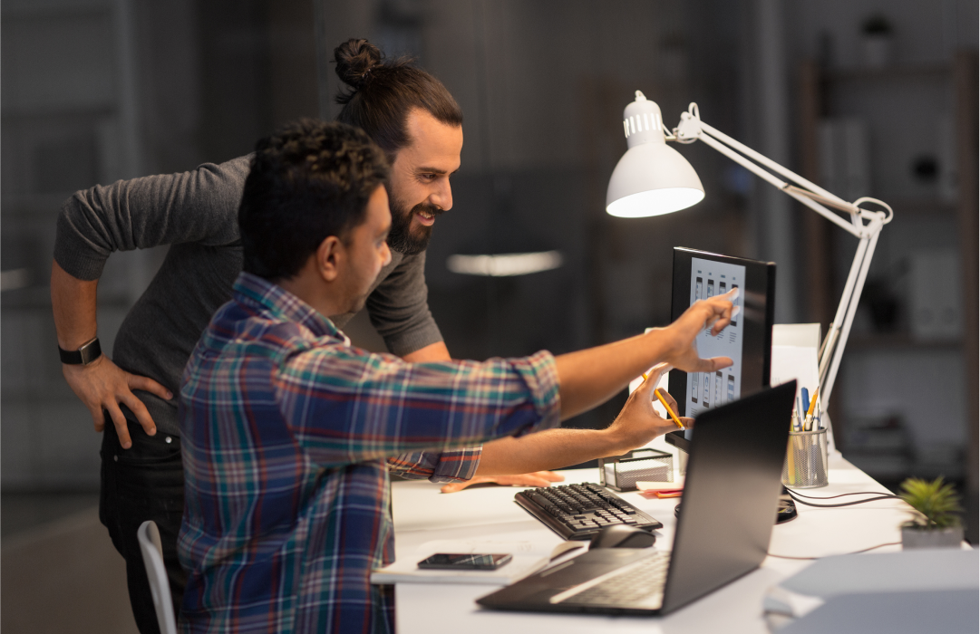 Developer showing coworker how to access Flex from ChatGPT interface on computer