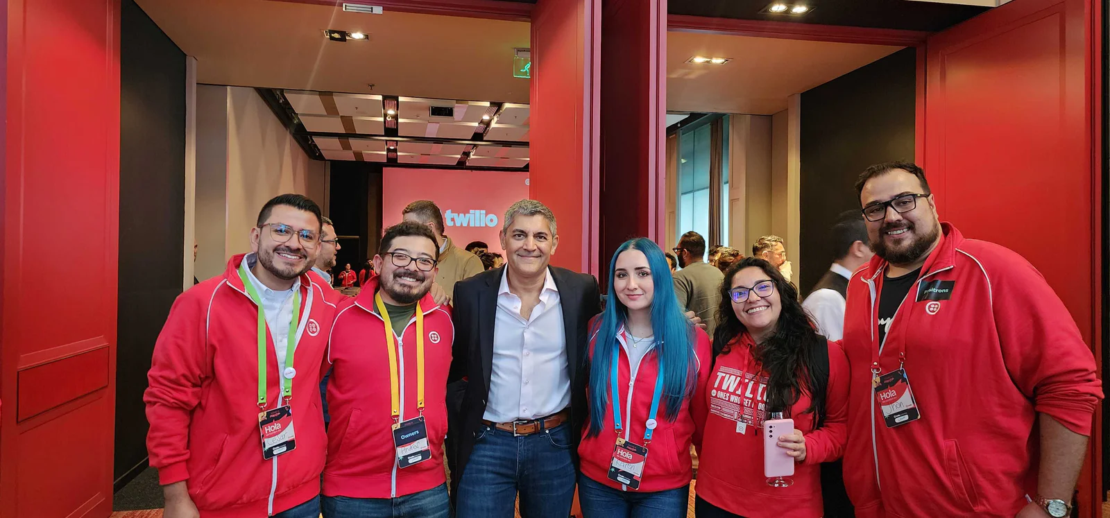 Group of six people standing together at a Twilio event, smiling at the camera.
