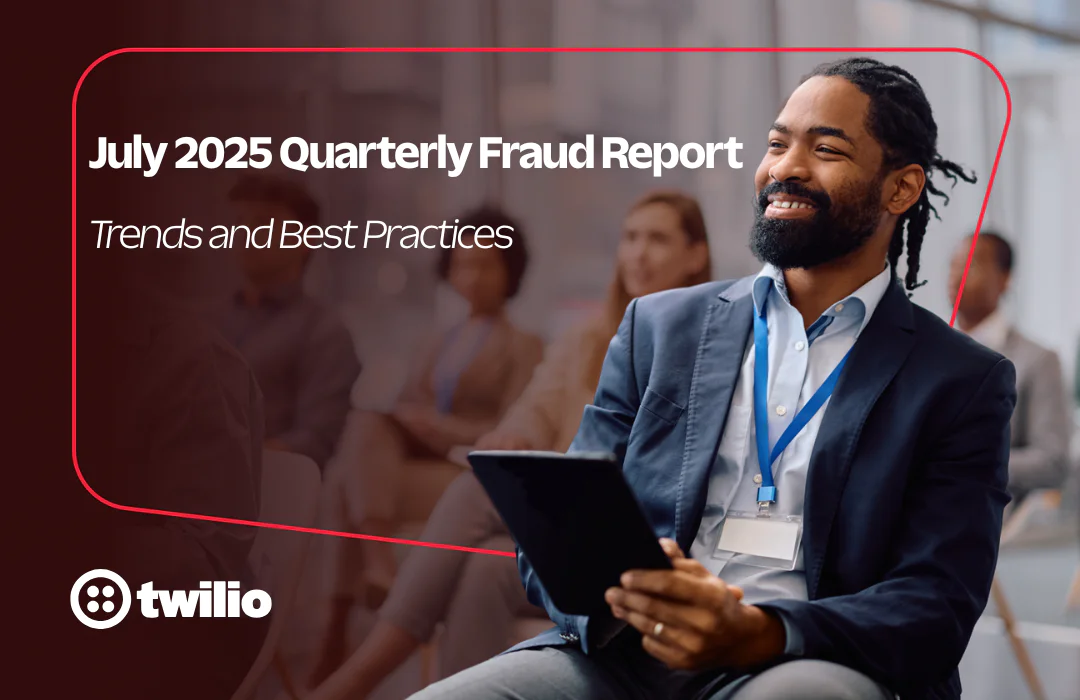 Smiling man in a suit holding a tablet at a Twilio event.