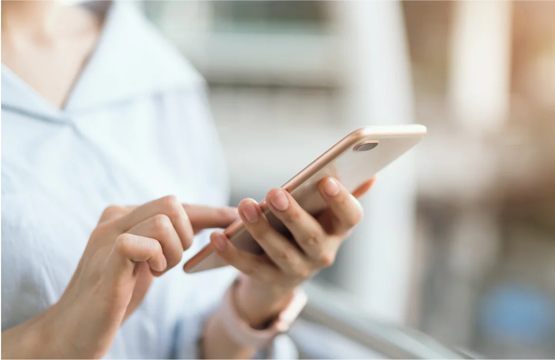Close-up of hands holding and using a smartphone
