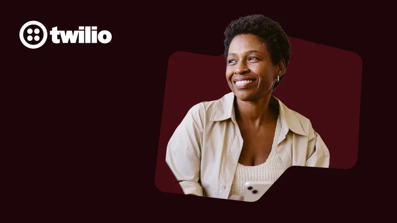 Smiling woman in a beige shirt with Twilio logo in the background.