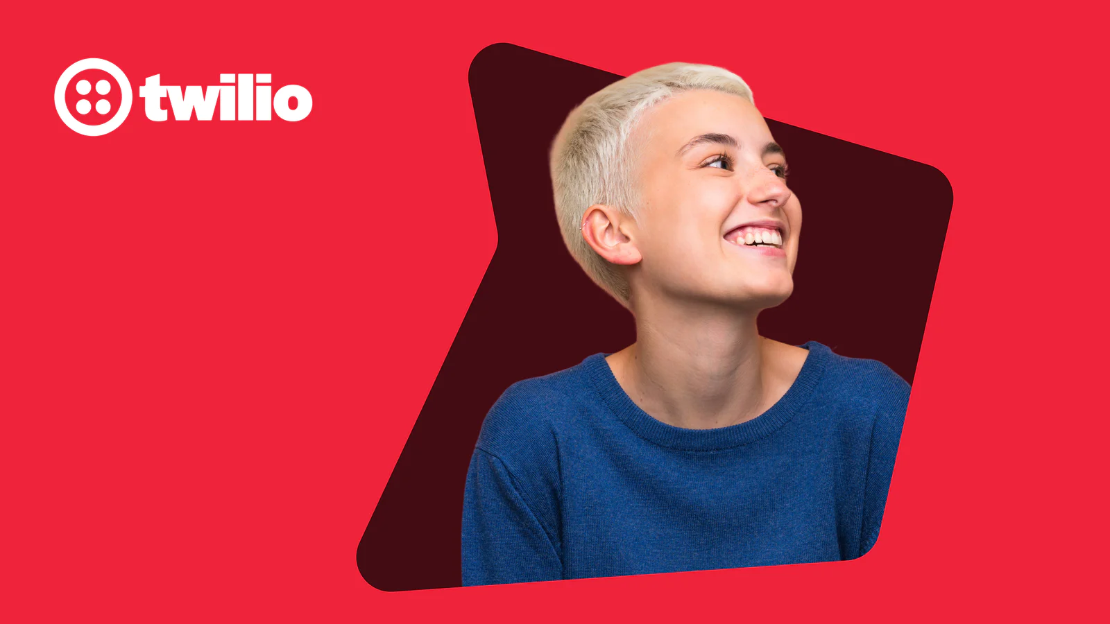 Person with short blonde hair smiling against a red background with Twilio logo