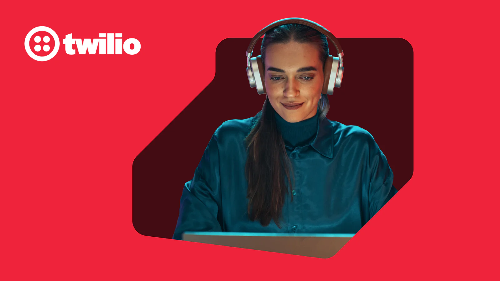 Woman with headphones looking at her laptop screen on a red background with Twilio logo