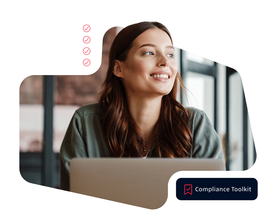 Smiling woman using a laptop with a compliance toolkit interface.