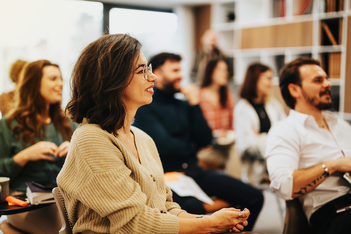 A group of people sitting and attentively listening during a workshop.