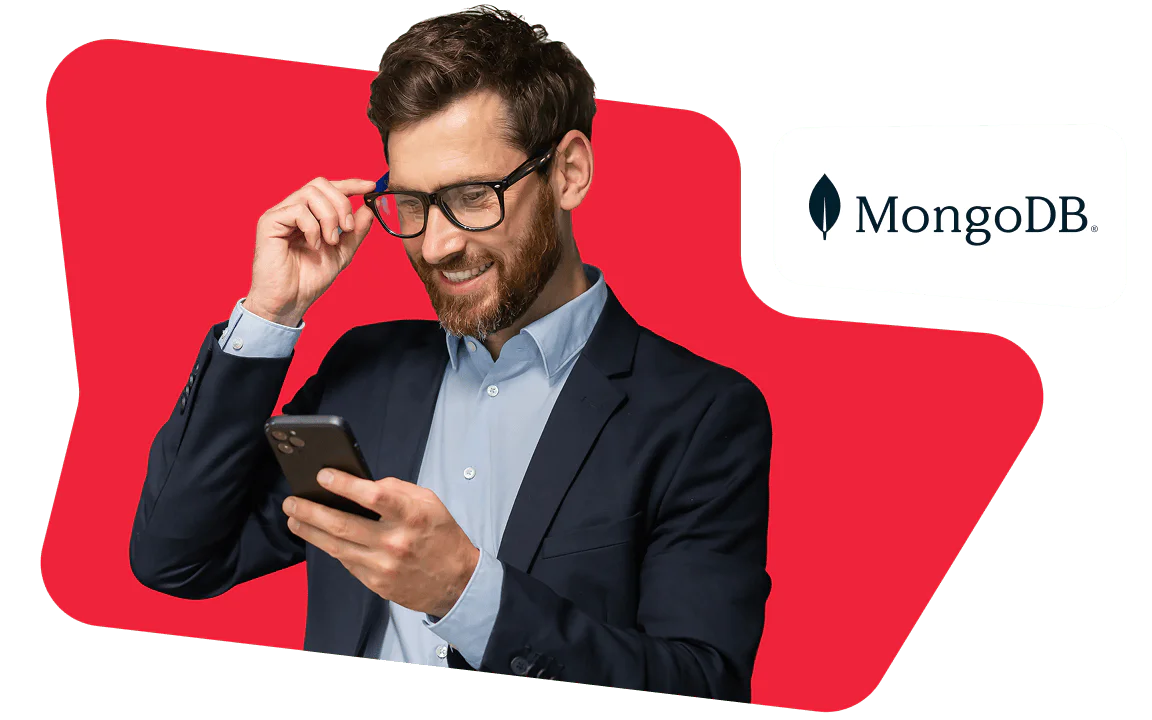 Man in suit looking at smartphone with MongoDB logo on red background.