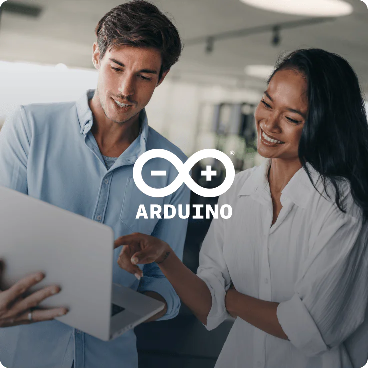 Two people discussing a project using an Arduino laptop. Two individuals looking at a laptop and discussing an Arduino project.