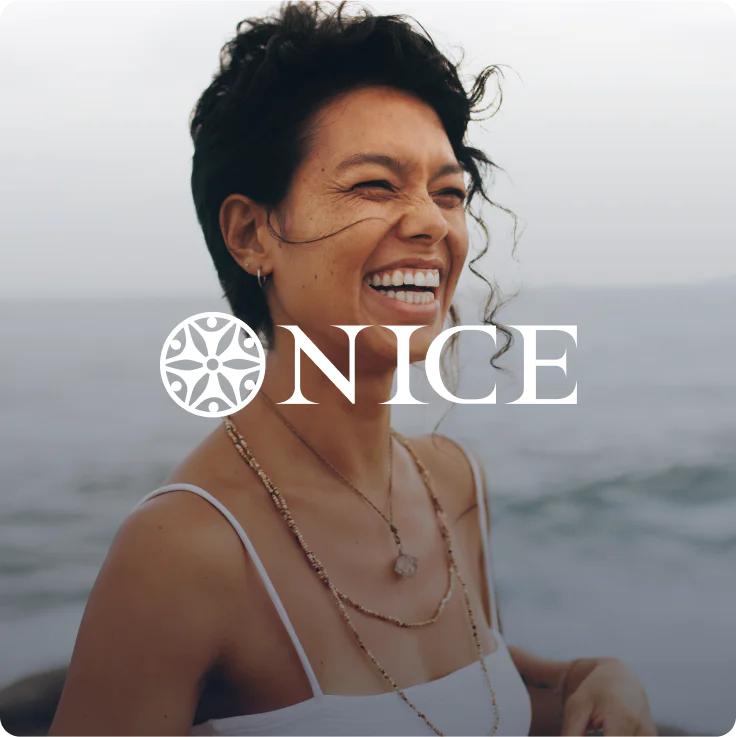 Carefree woman enjoying a joyful moment by the sLogo of Nice Company Card, showcasing peace and bohemian jewelry