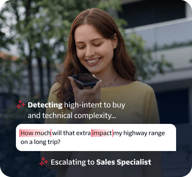 Woman speaking into a smartphone held in her hand while standing outside.