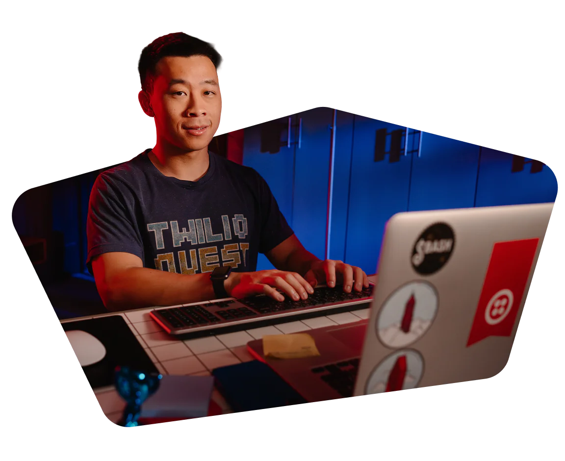 Man coding on a laptop with tech-themed background