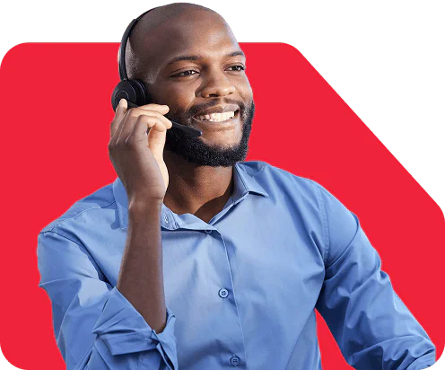 Man in a blue shirt smiling while using a headset
