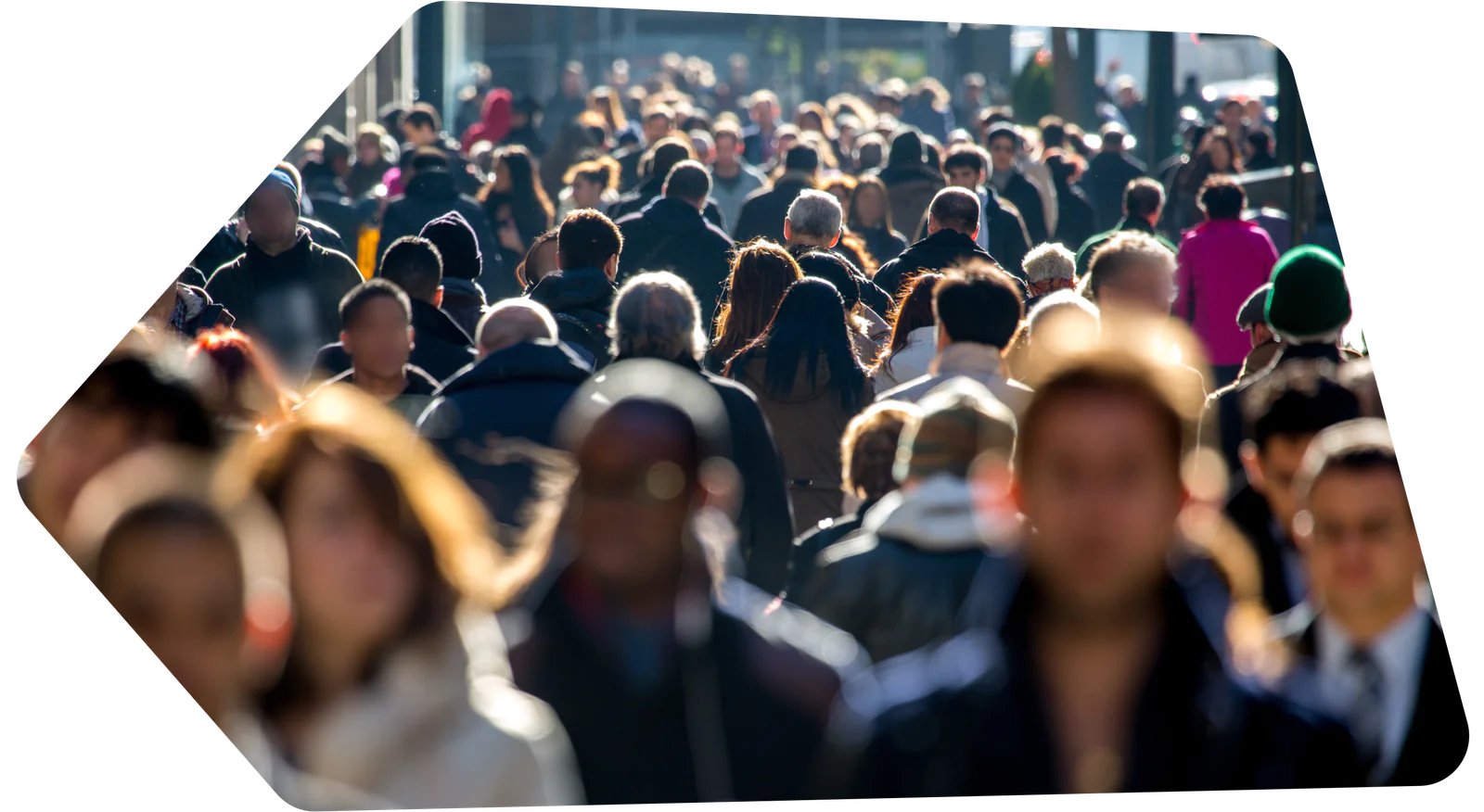 Crowded city sidewalk filled with people walking in various directions.