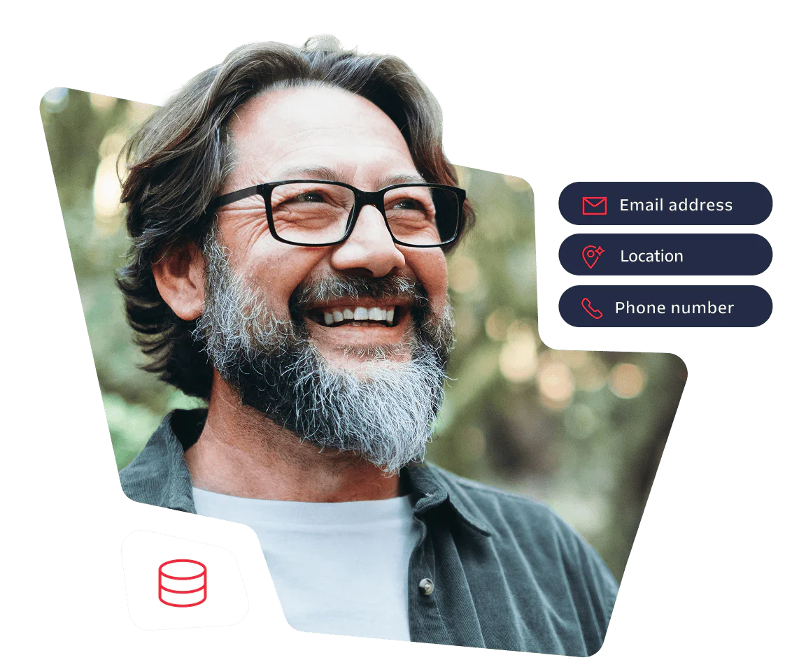 Happy man with glasses and beard in a forest setting Smiling man with glasses and beard standing outdoors in a forest background.