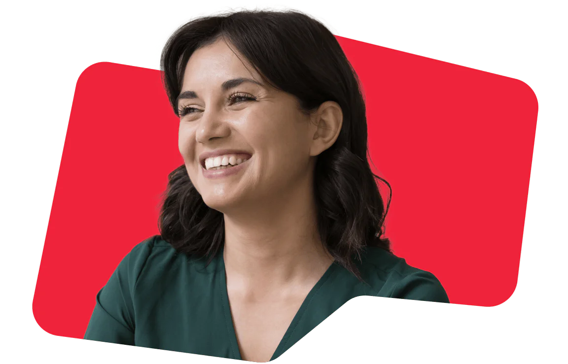 Smiling woman against a red background A woman smiles warmly, conveying positivity and happiness, set against a vibrant red background.
