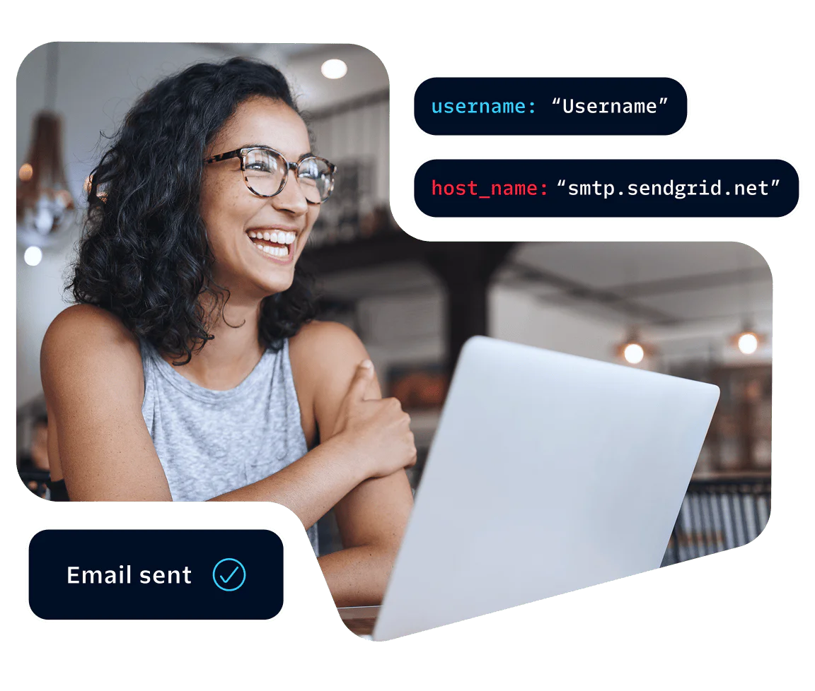 Woman wearing glasses smiling and working on a laptop with an email sent notification displayed.