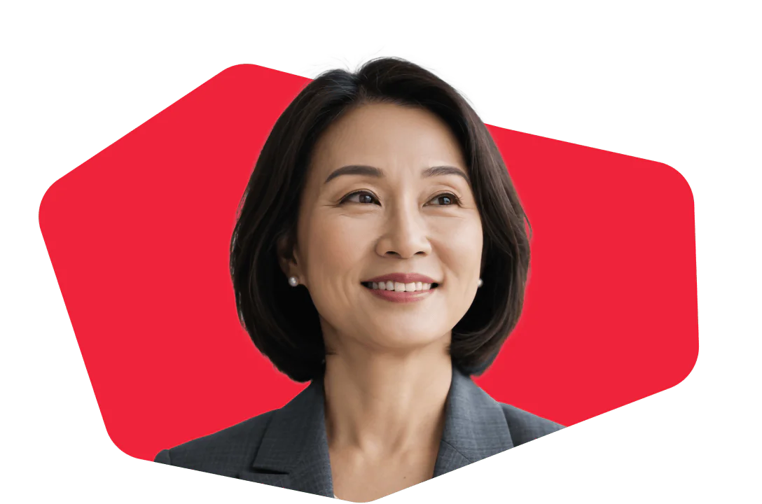 Asian woman in a business suit smiling in front of a red geometric background