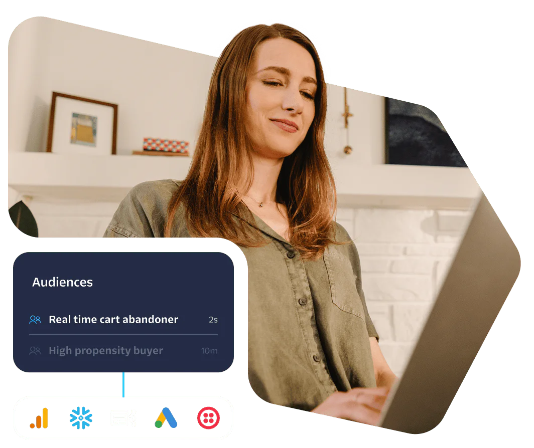 Woman looking at a laptop screen with data on audience engagement and behavior.