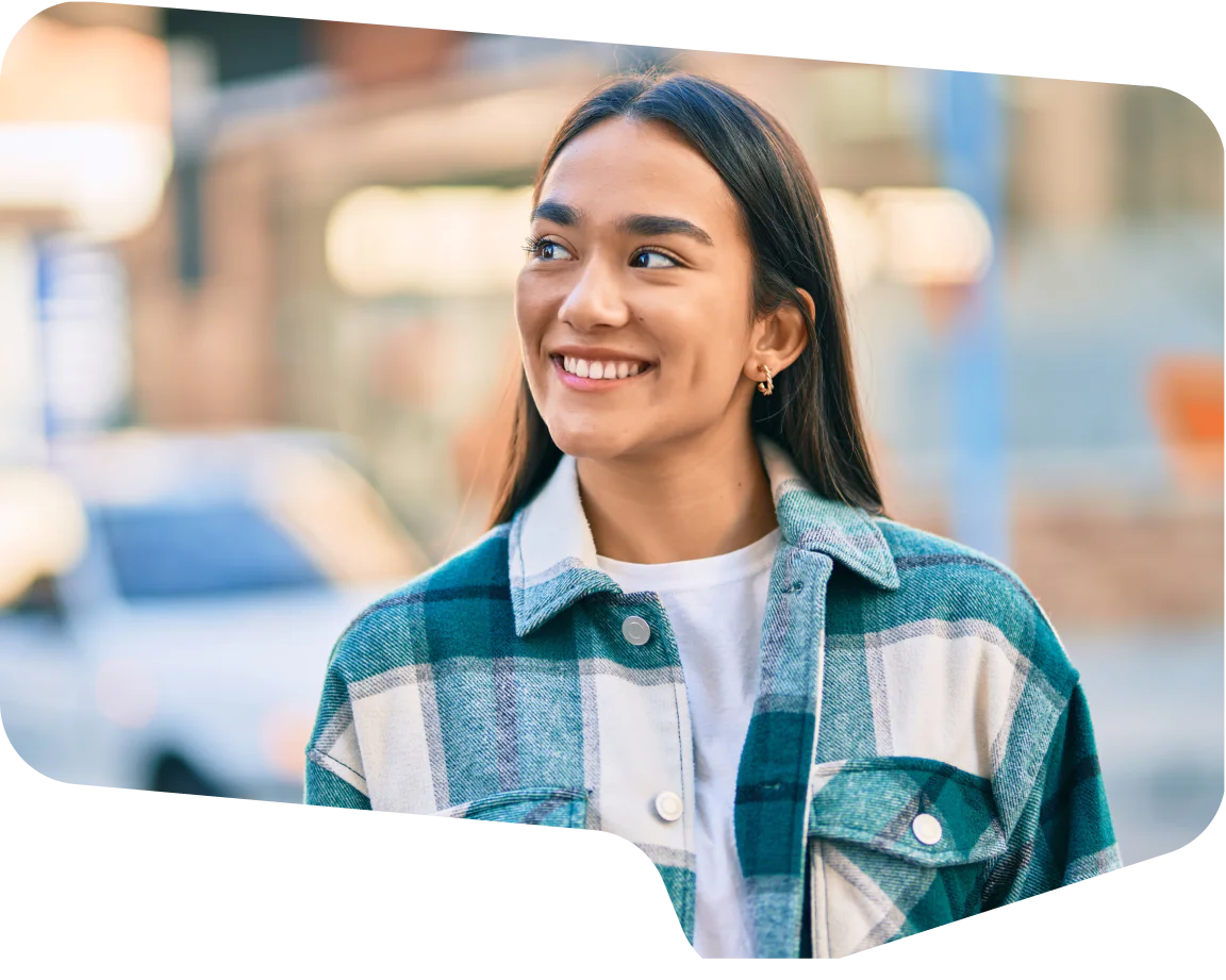 Transparent Checkered Pattern Smiling young woman wearing a plaid jacket with blurred city background