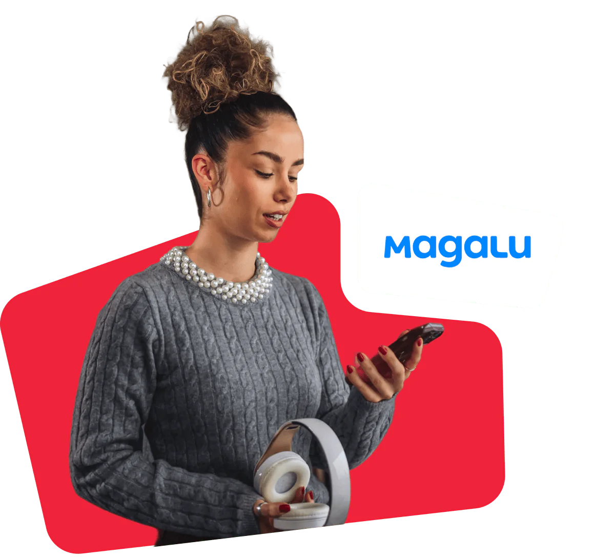 Woman holding headphones while looking at smartphone with Magalu logo in the background.