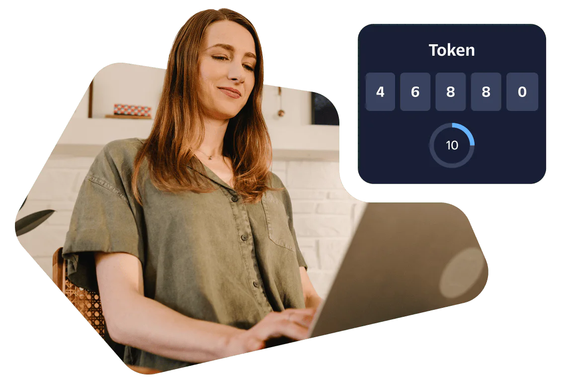 Woman typing on laptop with a six-digit token for two-factor authentication displayed on the screen.