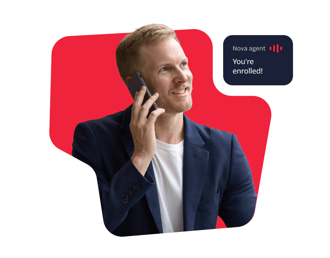 Smiling man in a blue blazer on a phone call with a booking confirmation message.