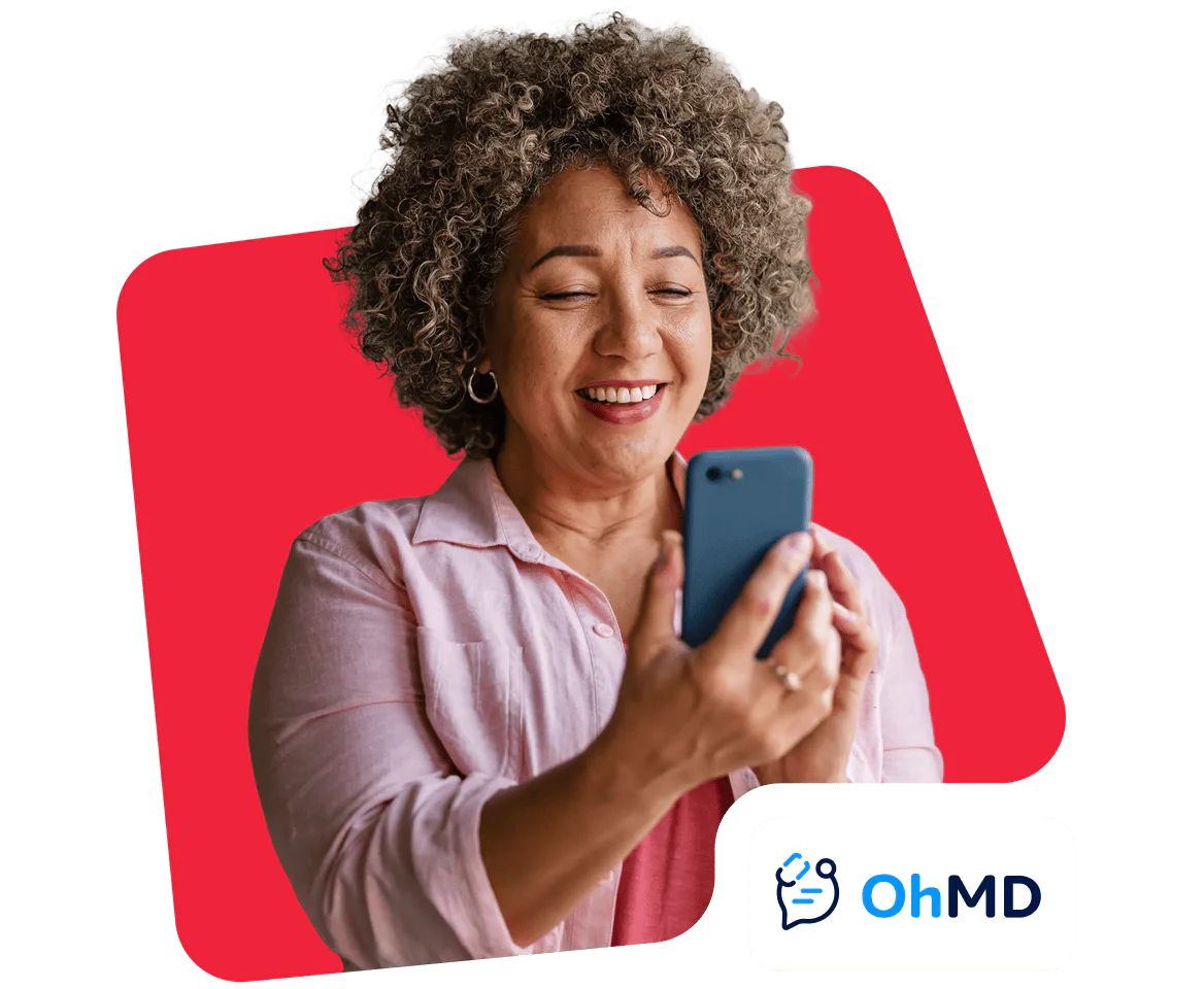 Smiling woman looking at her phone with OhMD logo on display