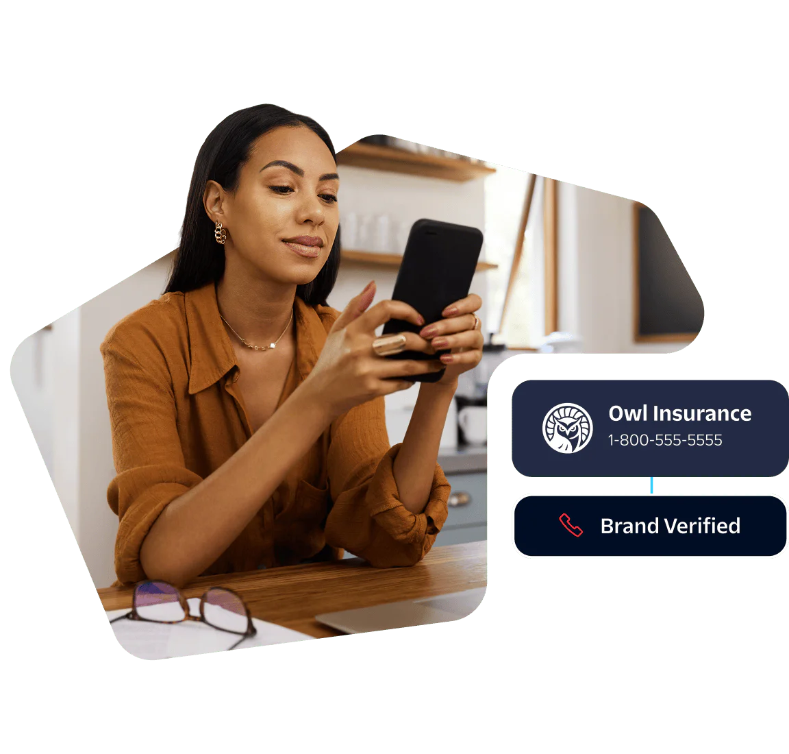 Woman in brown shirt looks at smartphone, Owl Insurance contact info displayed.