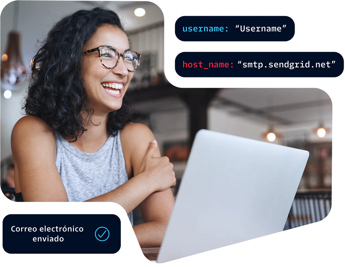 Woman wearing glasses smiling and working on a laptop with an email sent notification displayed.
