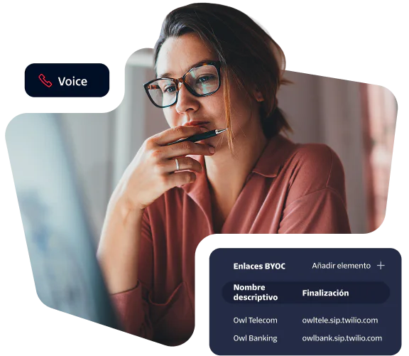 Woman in glasses looks intently at monitor, viewing telecommunications trunk terminations on screen.