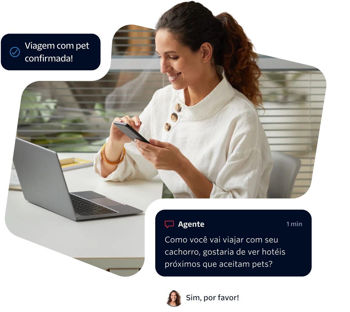 Woman using phone while chatting with virtual agent about pet-friendly hotels, laptop on desk.
