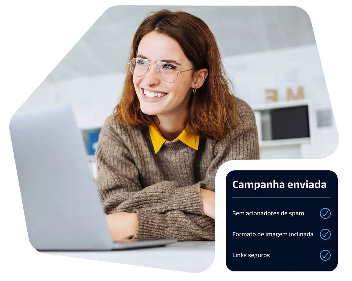 Woman wearing glasses smiling at a laptop with displayed campaign metrics.
